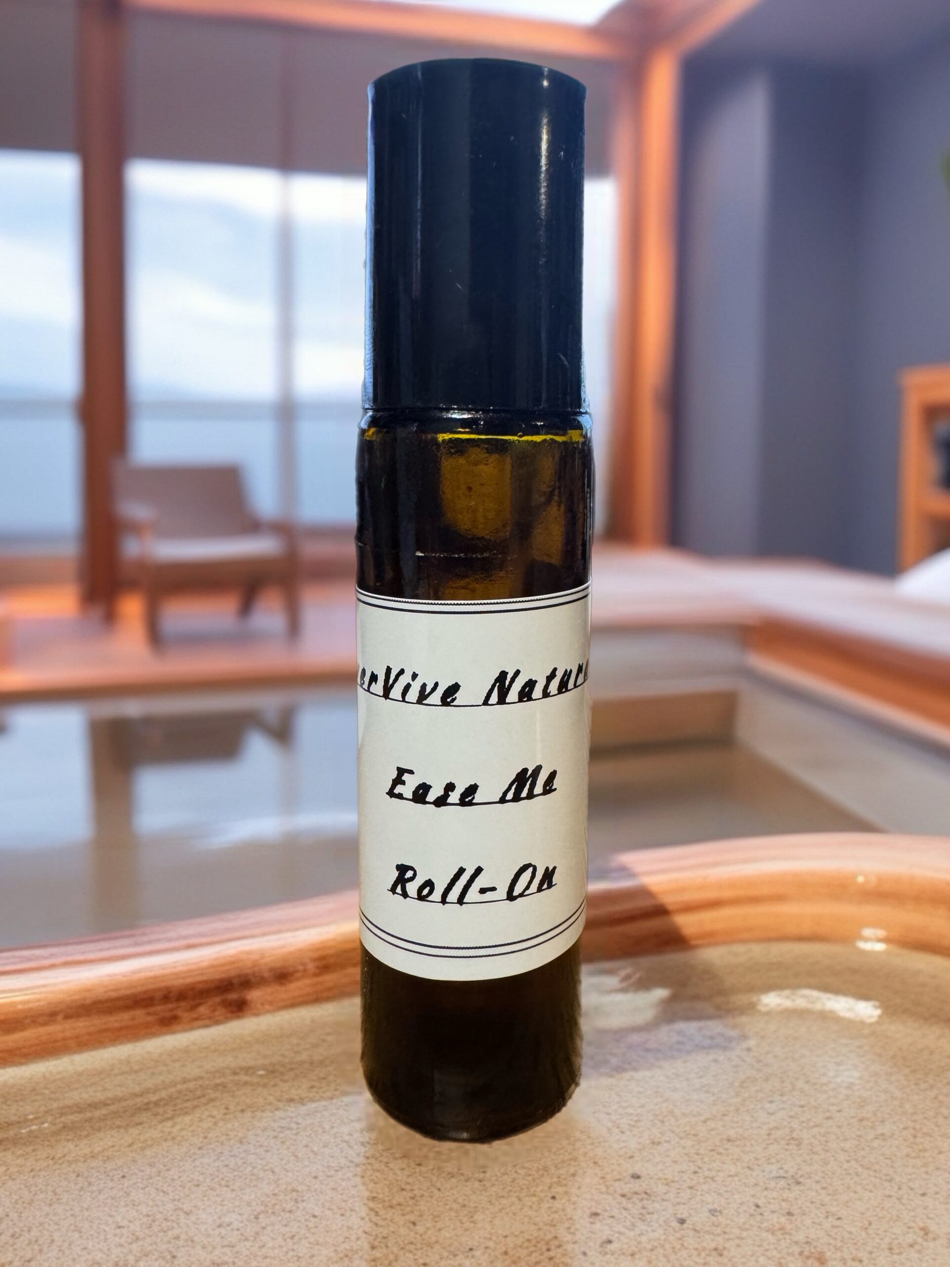 Ease Me Roll-On – calming essential oil roll-on with lavender, frankincense, and jojoba on soft fabric with dried lavender sprigs
