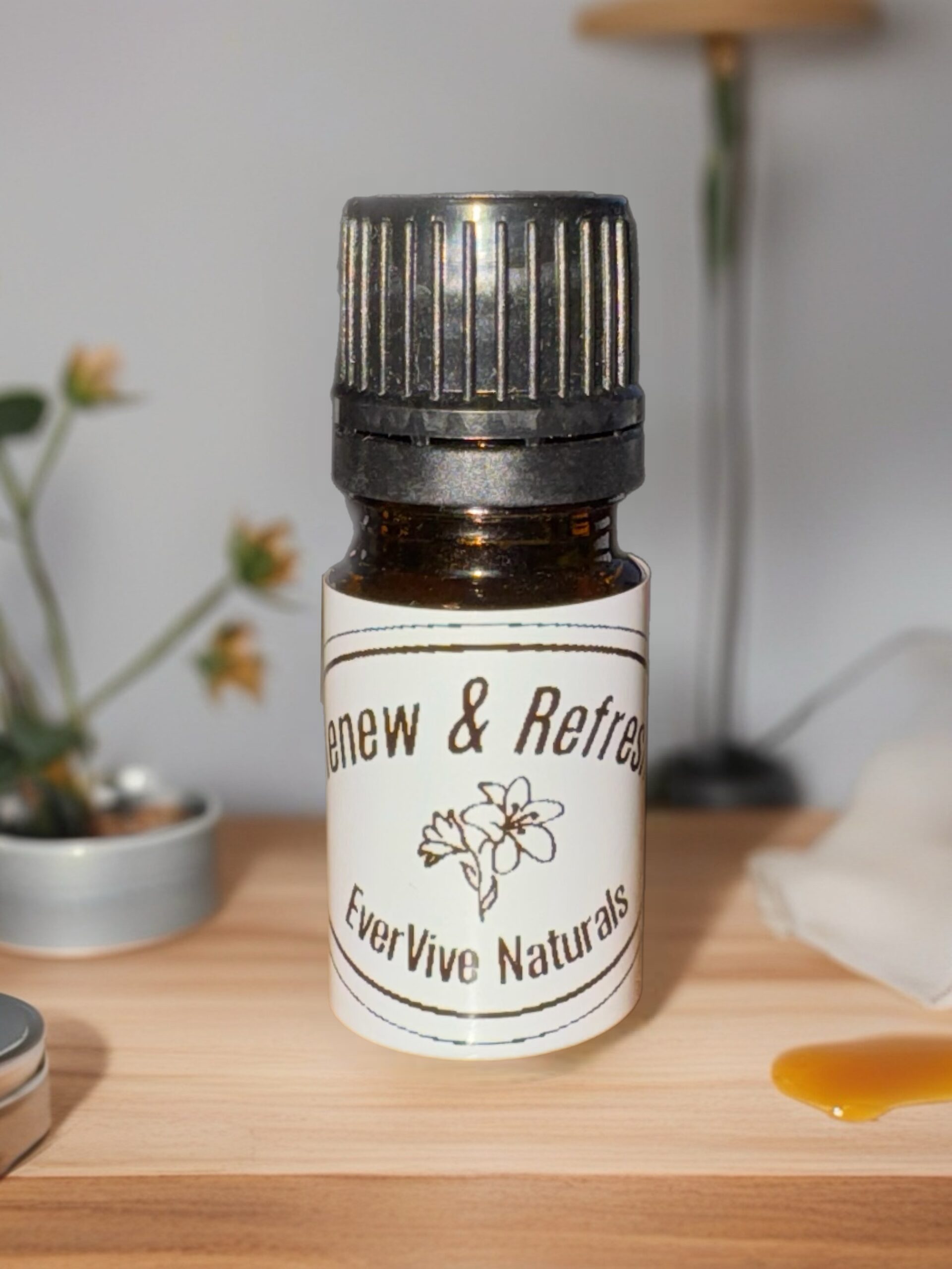 Renew & Refresh Blend – citrus and tea tree essential oil blend in amber bottle on clean white tile background with eucalyptus and lemon slices
