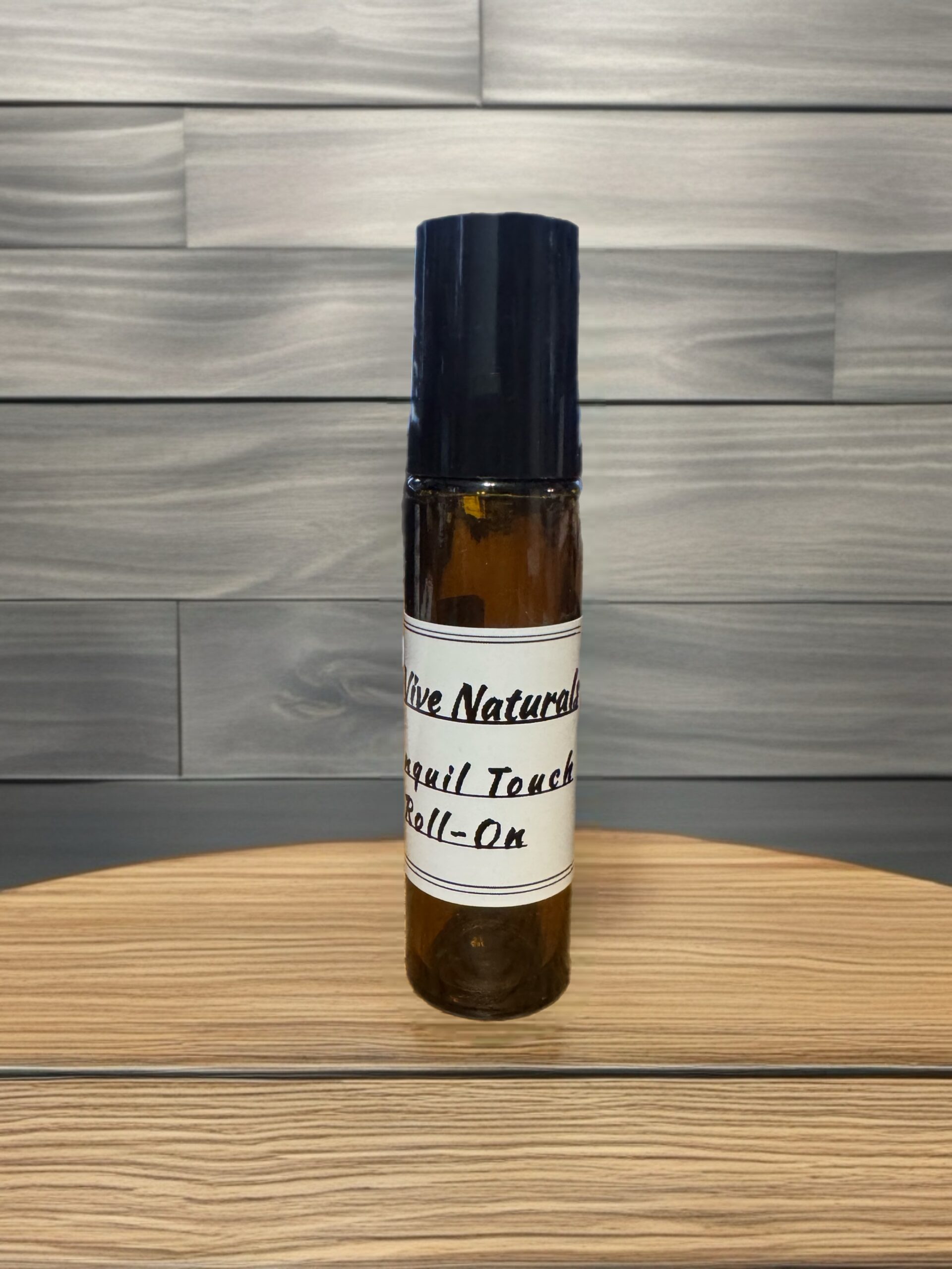 Tranquil Touch Roll-On – citrus and floral essential oil roll-on with grapefruit, lavender, and patchouli on linen with citrus slices and flower petals