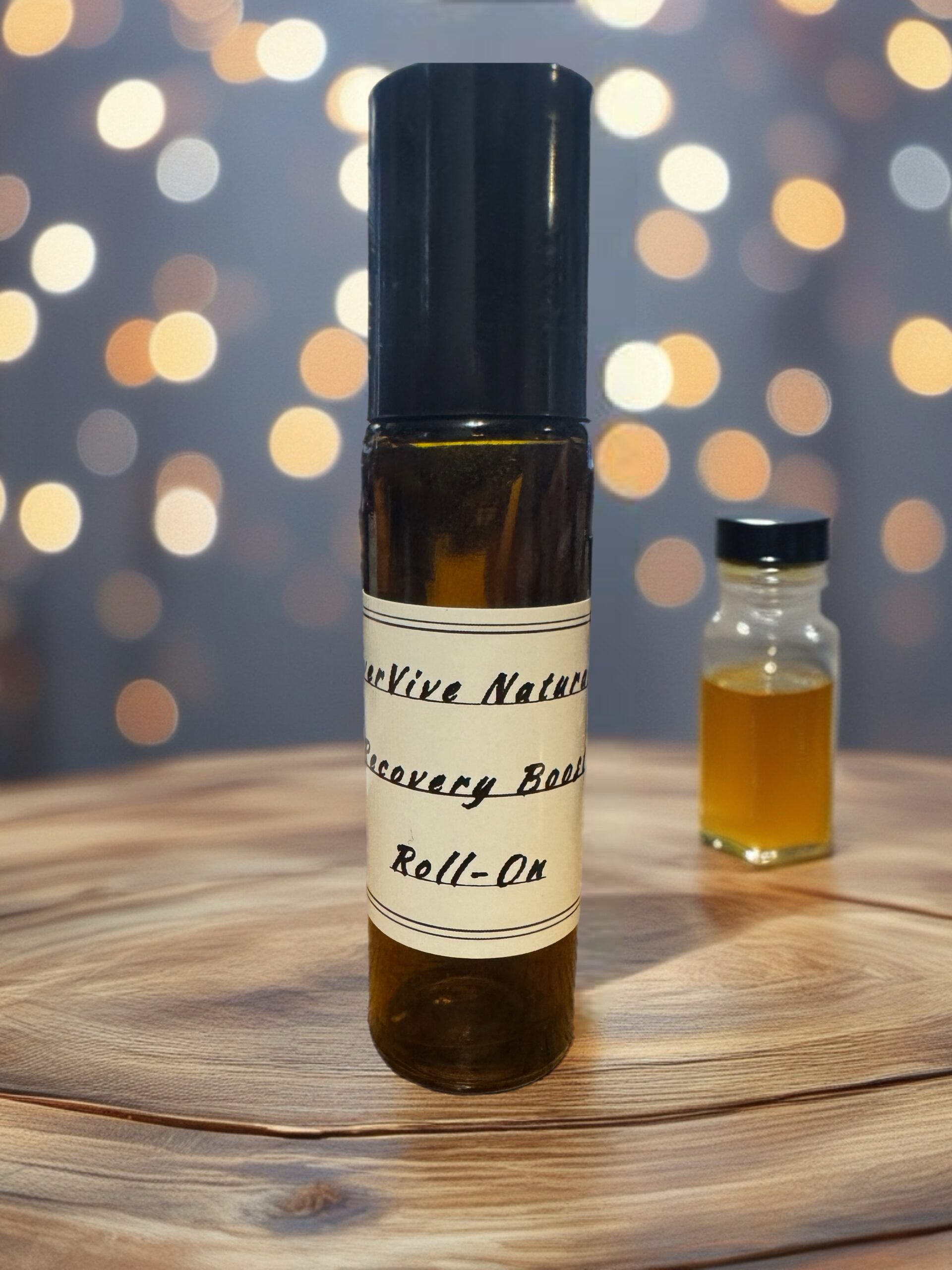 Recovery Boost Roll-On – essential oil roll-on with lavender, spearmint, and frankincense on gym towel with lemon slices and eucalyptus leaves