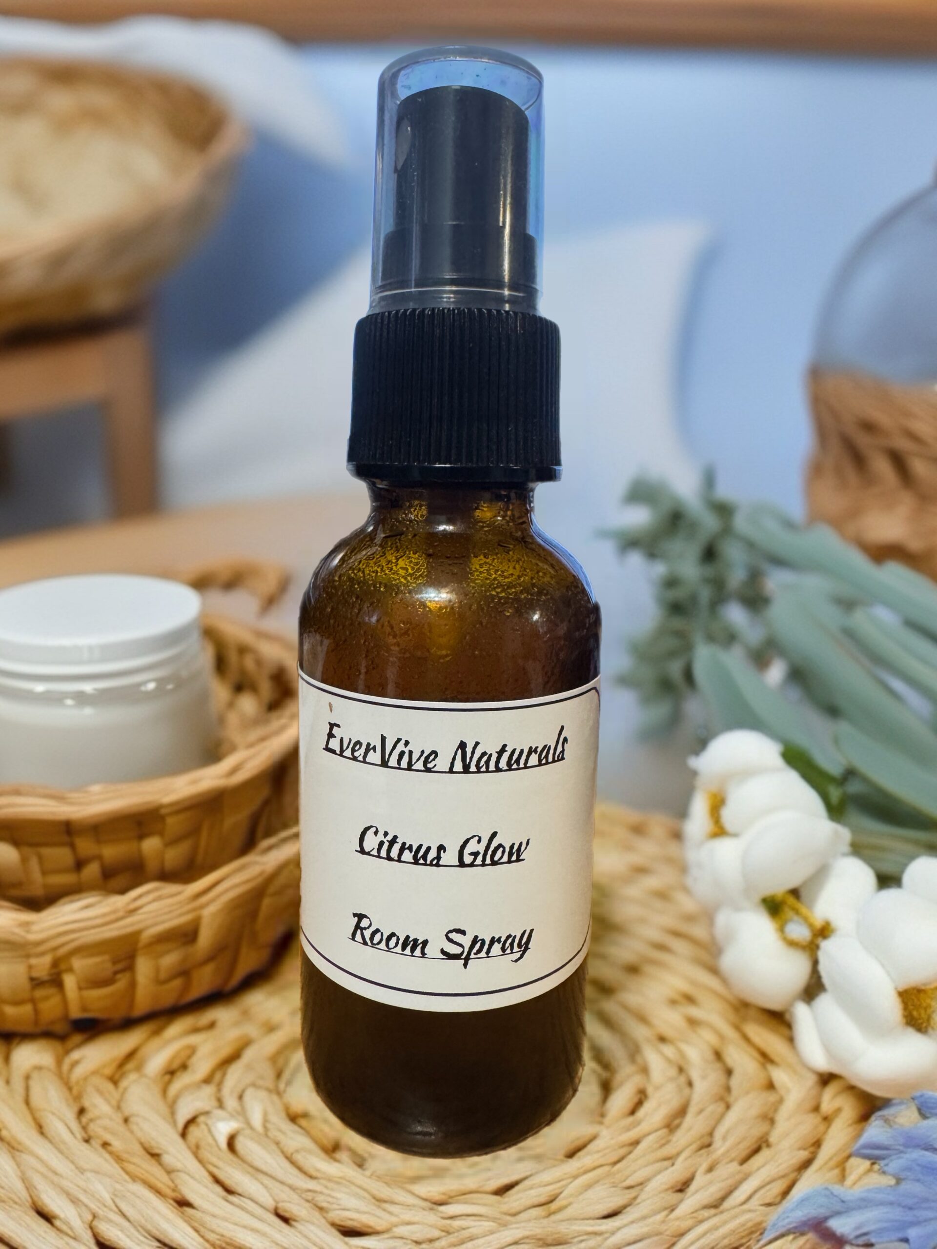 Citrus Glow Room Spray โ citrus and botanical room mist with orange, ylang ylang, and sage on sunlit windowsill with citrus slices and greenery