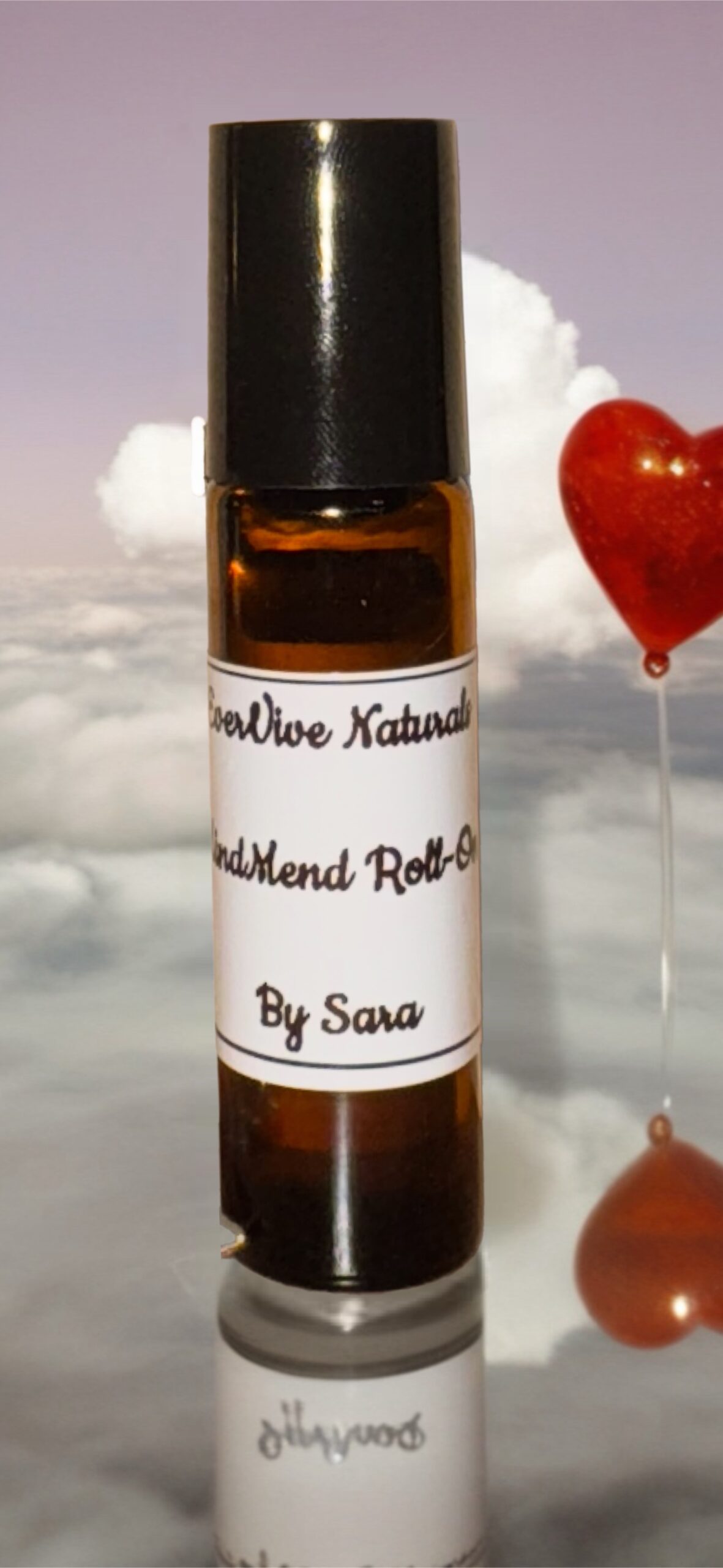 Mind Mend Roll-On – essential oil roll-on with peppermint, lavender, and frankincense on marble tray with cool towel and eucalyptus leaves