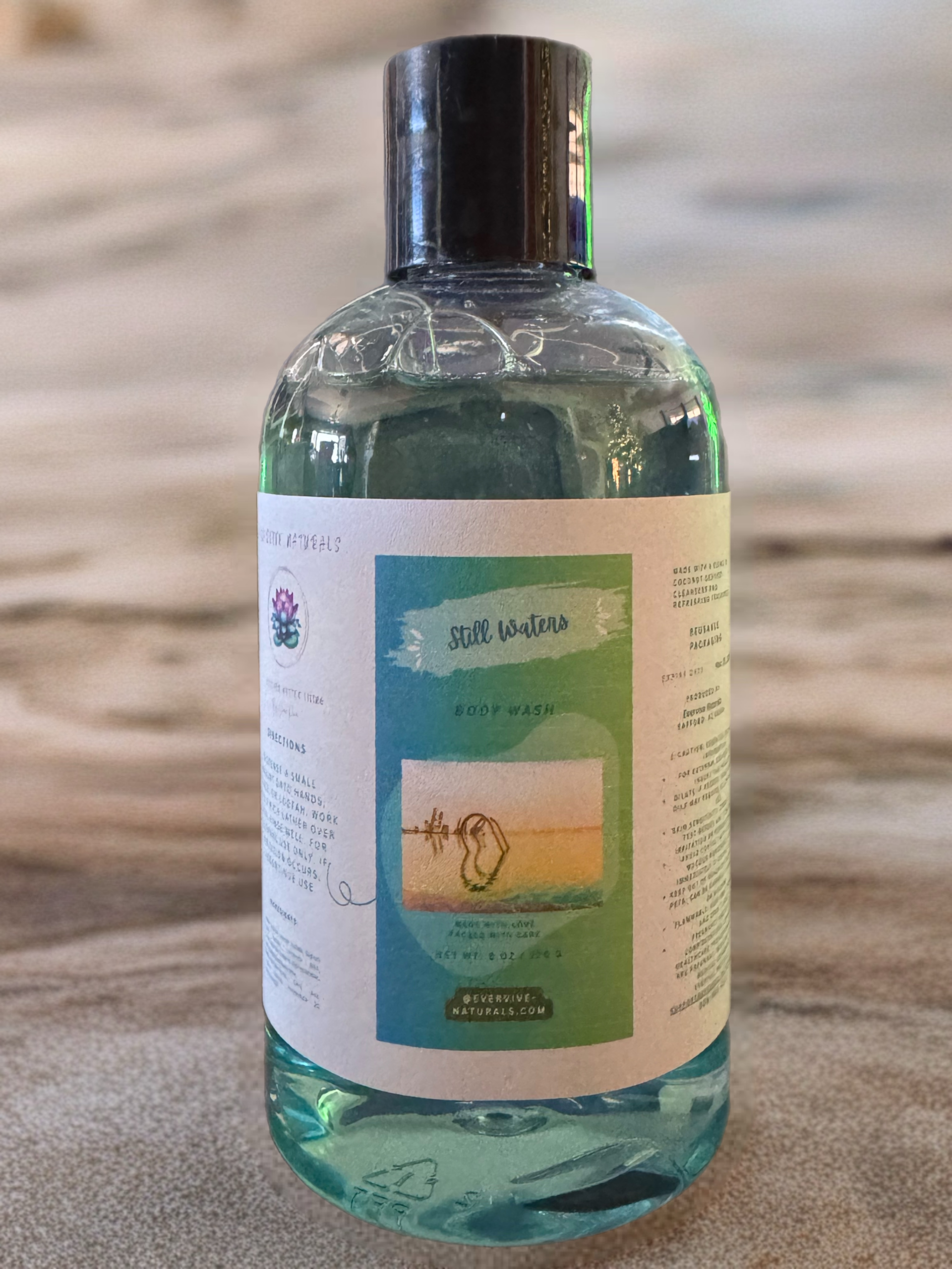 Still Waters body wash bottle in regular and exfoliating formulas, gentle cleansing skincare product.